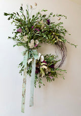 Handcrafted BETWIXT botanical wreath with dried dahlia, honesty, statice, eucalyptus, and natural grasses on a vine base in soft earthy tones.